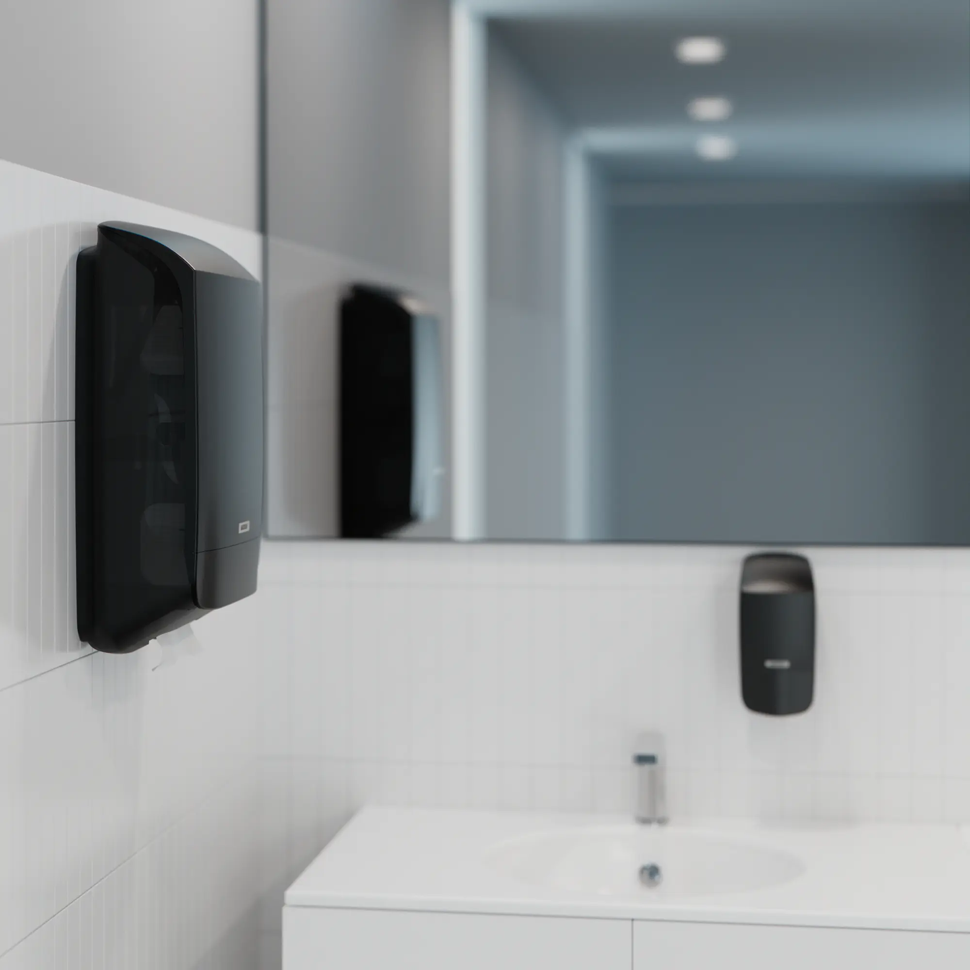 Katrin Handtuchpapierspender M in Schwarz aus schlagfestem Kunststoff, an der Wand im Waschraum montiert, passend zu Katrin Seifenspendern, Art.-Nr. 77410